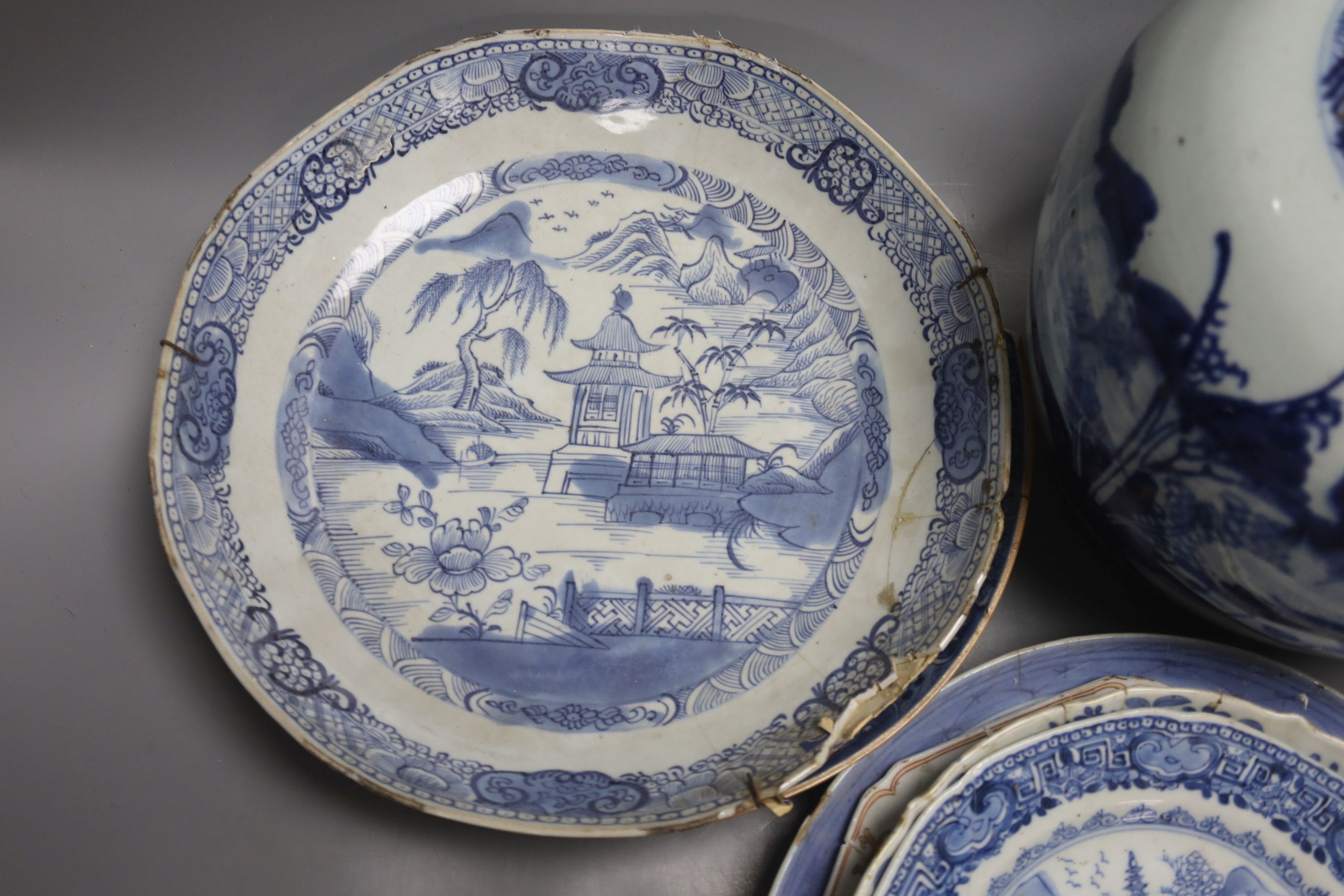 A group of 18th century Chinese export blue and white dishes, plates and a jar, the jar 21.5cm high